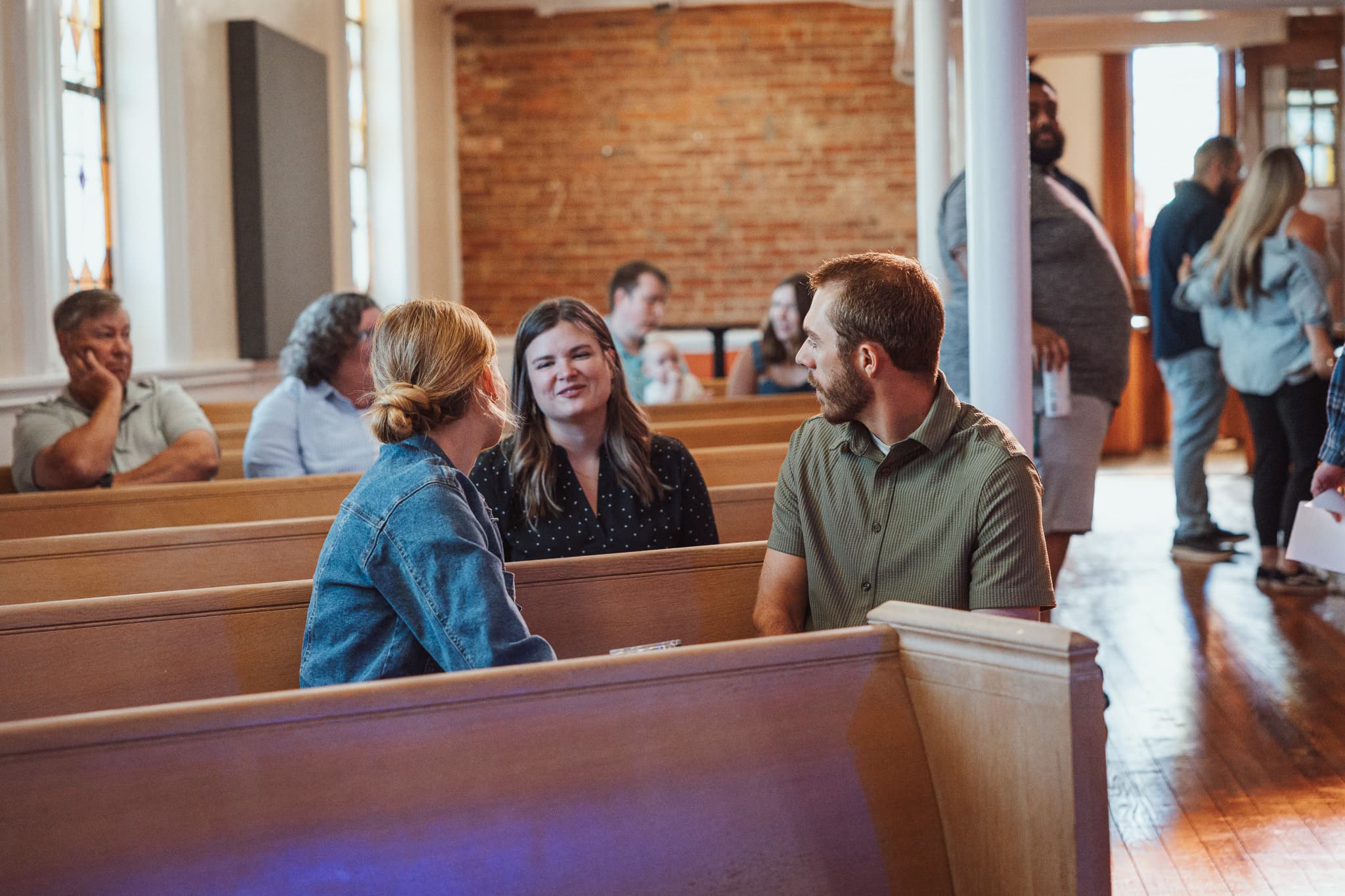 Friends in conversation across the pews